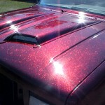 Rose Red Flake paint on hood of Ford Explorer.