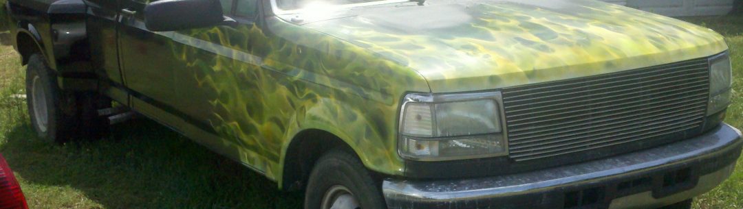 Multiple green and yellow flames on truck hood