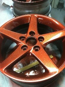Orange copper metal Flake on a wheel