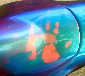 Temperature changing paint on Chameleon Super-Bike. John Haro's handprint on his thermochromic pigment painted motorcycle tank. Temperature changing chameleon!.